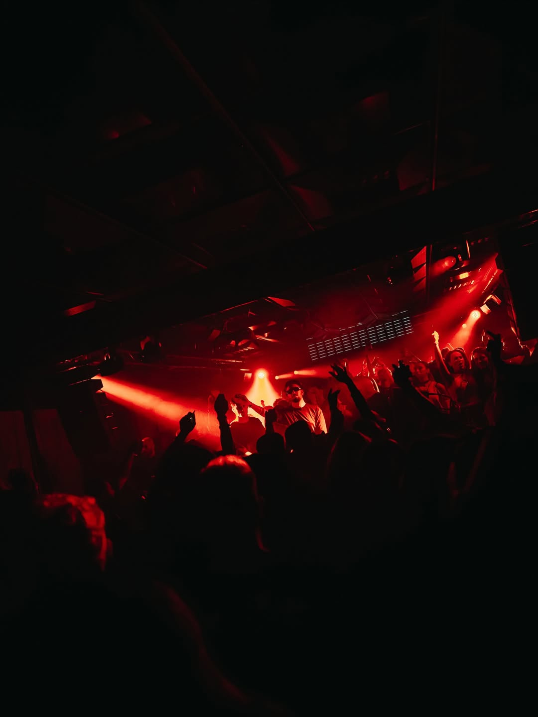 Art Inquiry electronic music night at Noar Hall — crowd under red ceiling lighting